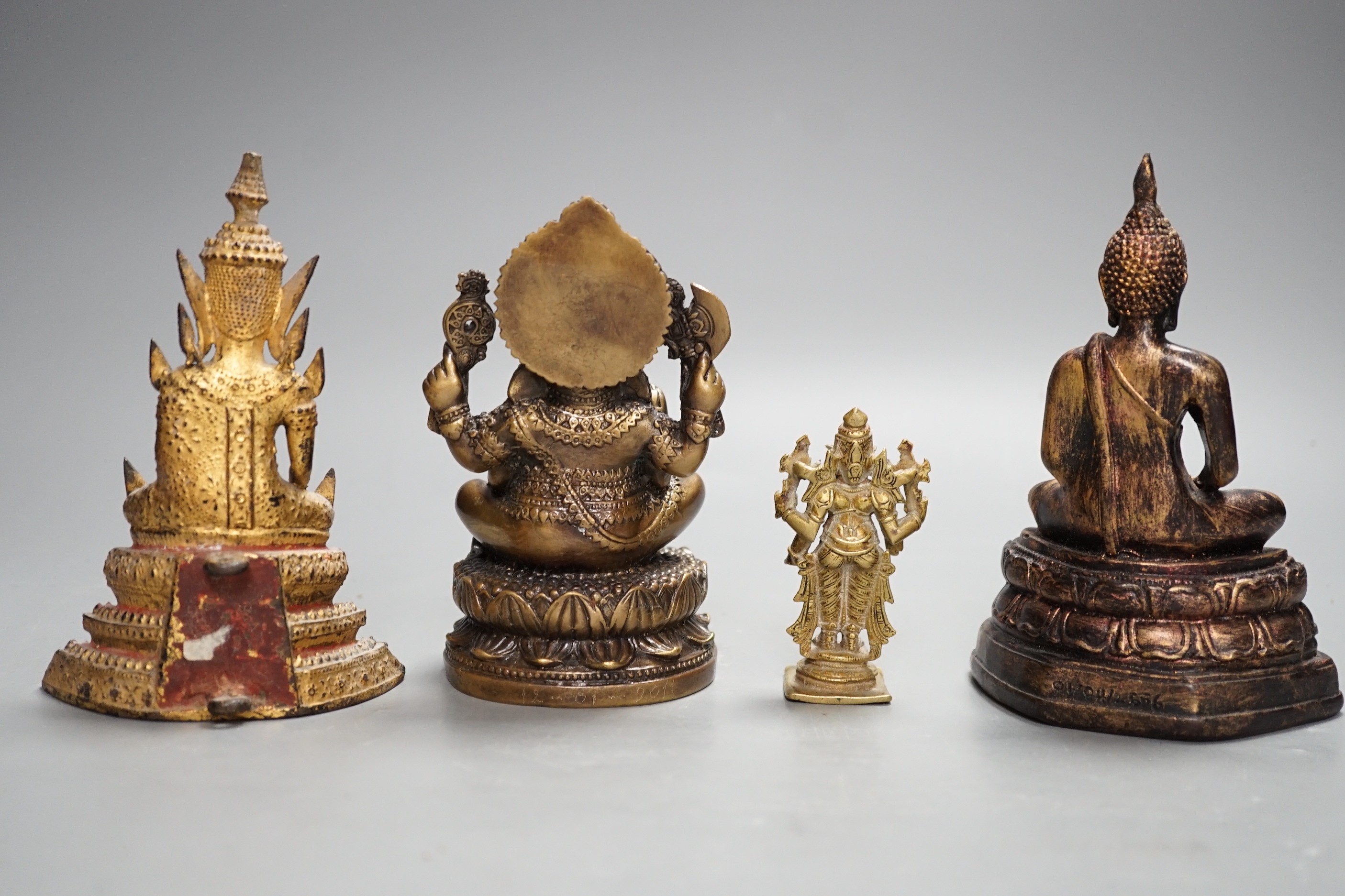 A Thai gilt resin model of Buddha, an Indian bronze model of Ganesh, a jadeite coloured carving of Guanyin and two other figures. Tallest 30cm